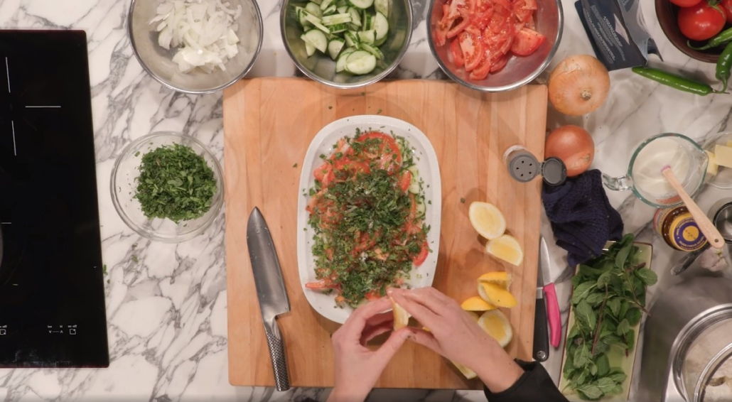 cucumber salad being seasoned