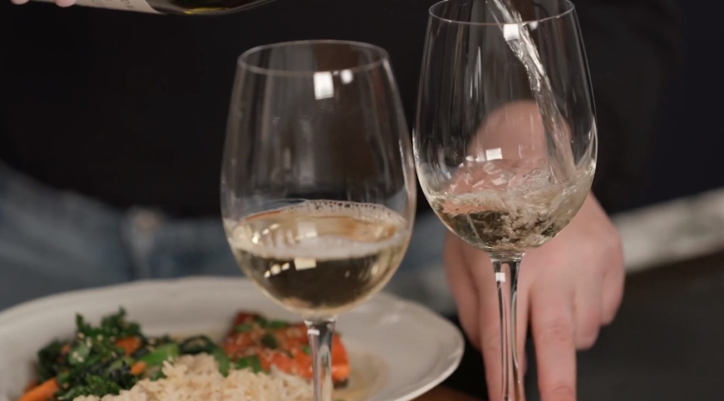 Pinot Gris being poured with salmon dish